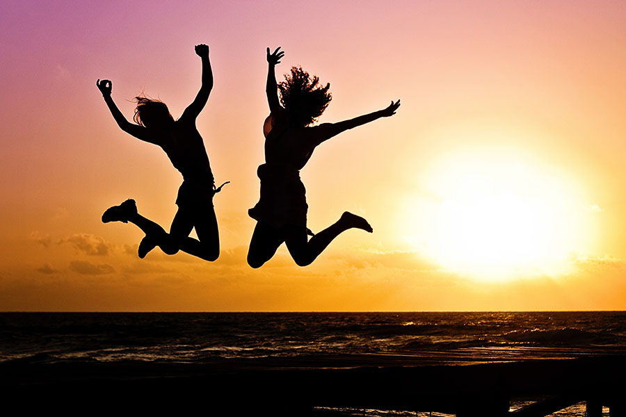 People Jumping on Beach