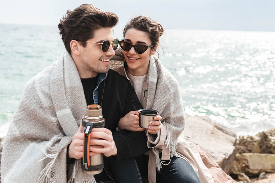 couple drinking coffee at the waterfront