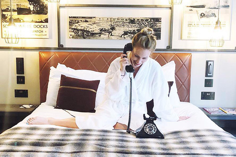 Woman on bed on phone